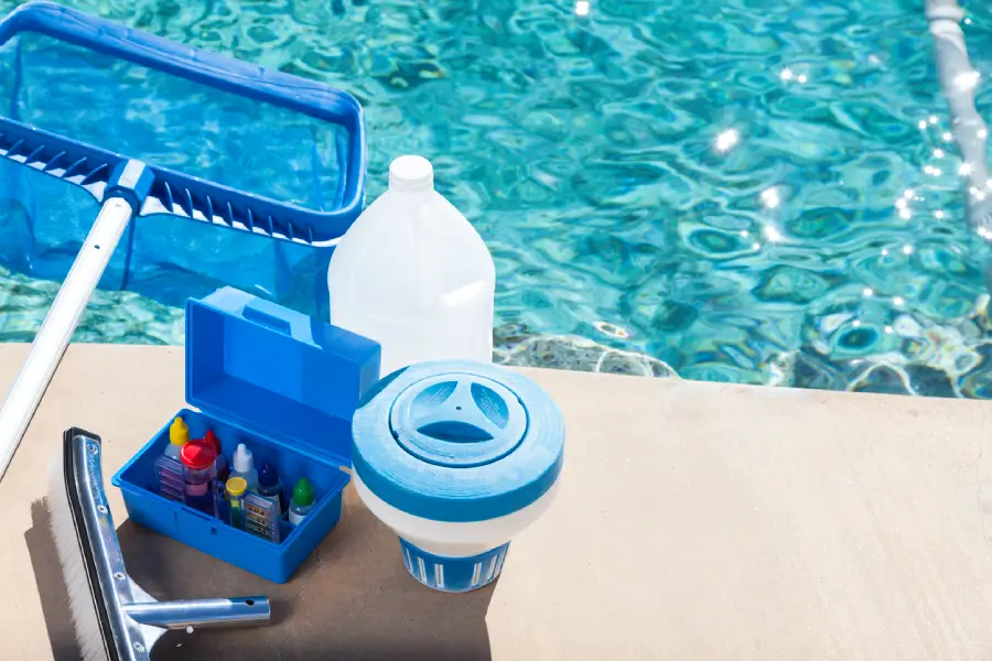 Pool supplies organized on pool ledge for cleaning