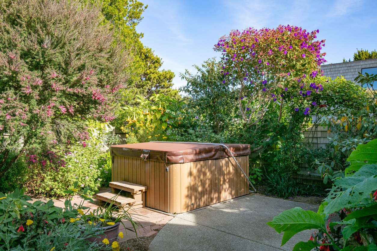 Hot tub not in use in backyard area with cover on top